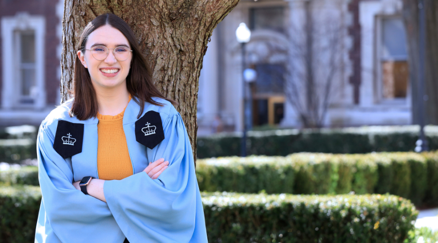 Jane Loughman poses in graduation robes